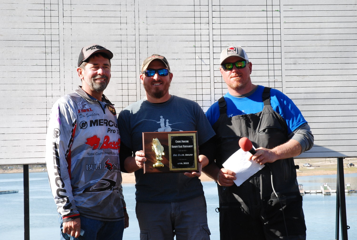 Dan Singletary (left) presents the 1st place Big Bass plaque to Eli Powers (center)  and Trey Anderson